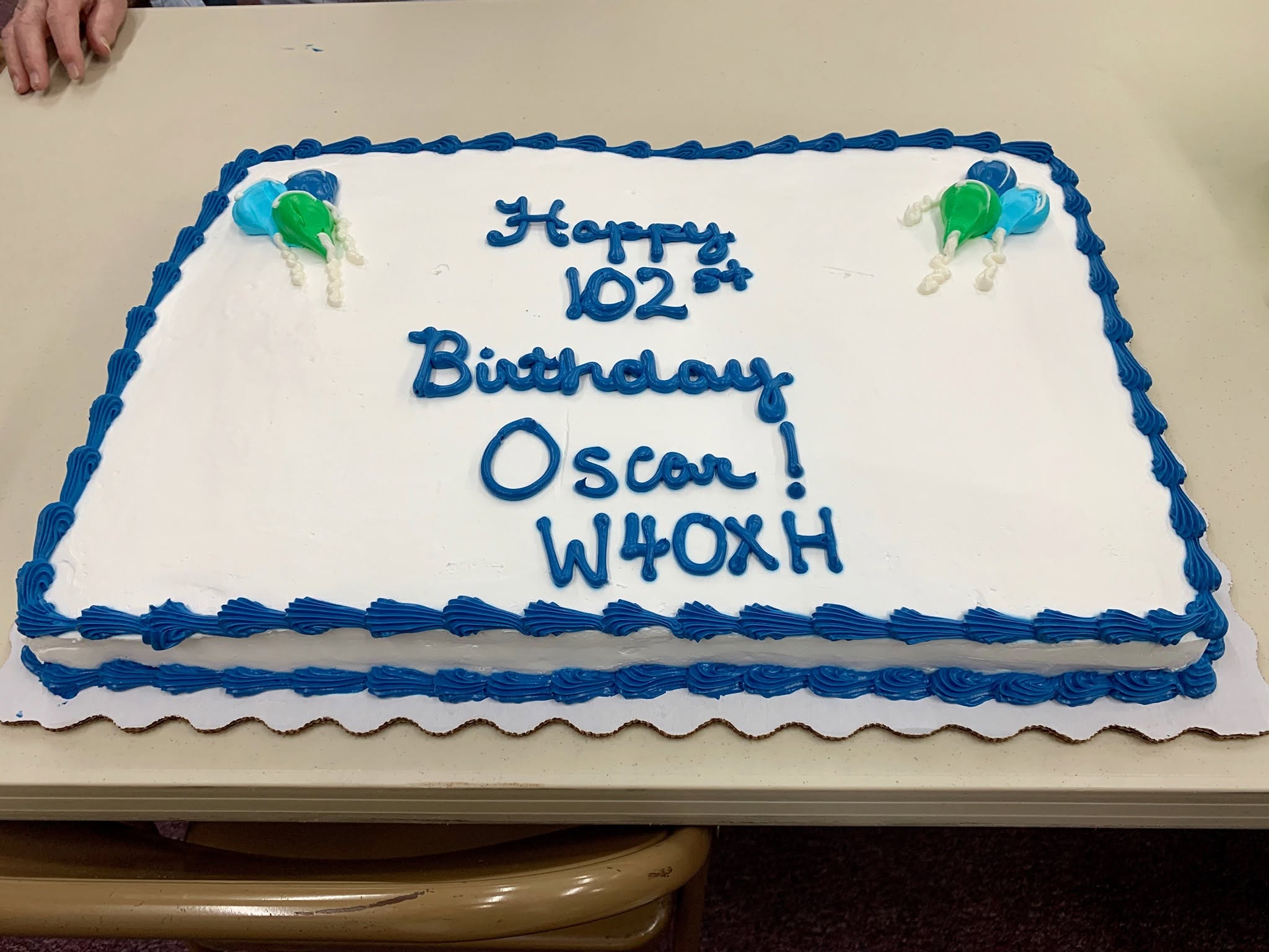 A cake celebrating Oscar Norris's 102nd birthday with W4OXH written in icing