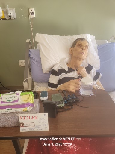 Walter Hendrickson, VE7BGJ, in hospice with amateur radio equipment and a VE7LEE card nearby.